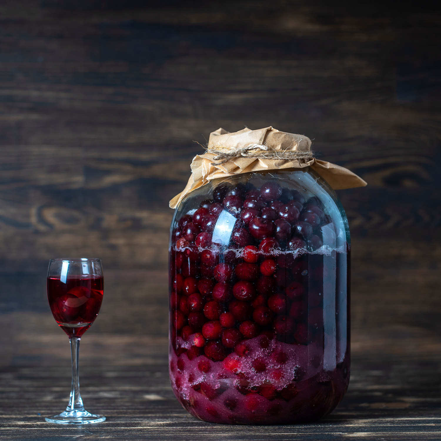 Ciliegie immerse in liquore al Moscato d’Asti in grande jarra di vetro.