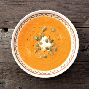 Vellutata di zucca cremosa con gocce decorative di panna